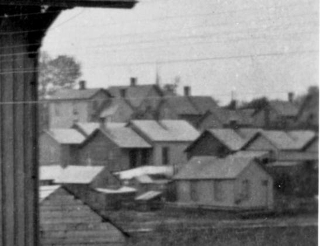 Detail of houses in far background at right.