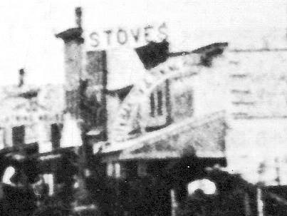 Detail of "Stoves" Sign on Right